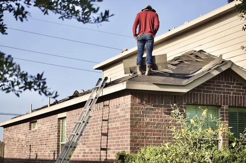 Professional roofer working on a residential roof in Edgemere